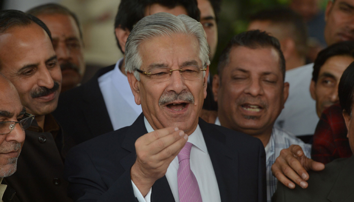 Defence Minister Khawaja Muhammad Asif (C) speaks to the media after a hearing over the Panama Papers in Islamabad-Photo AFP