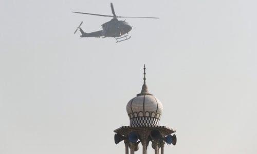 Photo shows military helicopter flying overhead during operation