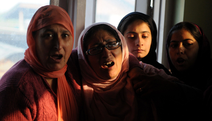 Kashmiri relatives of Qaiser Hamid, 16, mourn during his funeral-Photo AFP