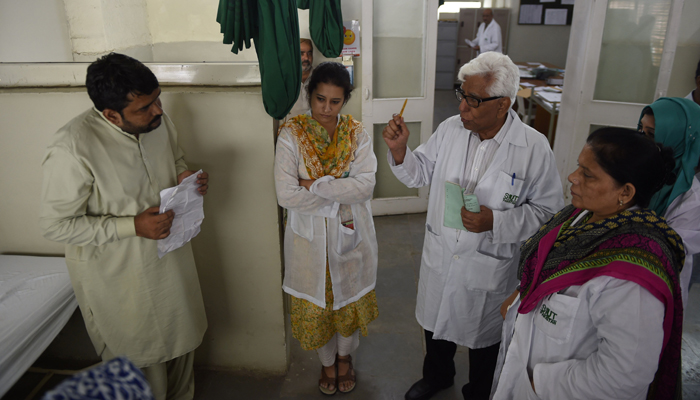 In this photograph taken on August 3, 2016, Pakistani doctor Adibul Rizvi (2nd R), head of the Sindh Institute of Urology and Transplantation (SIUT) speaks to patients and carers in Karachi - AFP