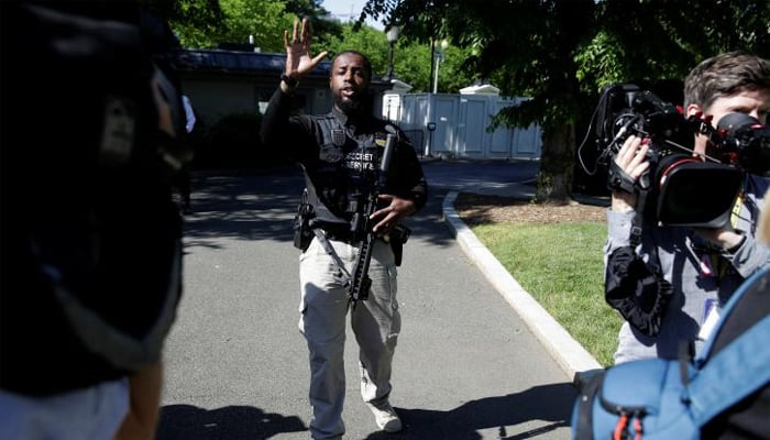 A Secret Service officer asks the media to leave the North Lawn in reaction to an apparent fence jumper at the White House in Washington, US, May 16, 2017. REUTERS/Joshua Roberts