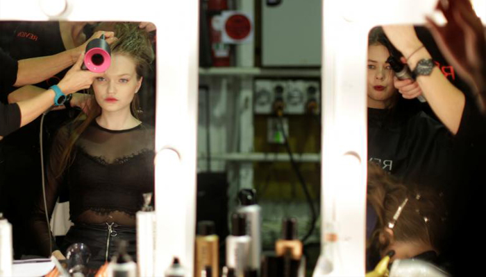 Models are reflected in mirrors backstage before a show by the Australian designer Steven Khalil. REUTERS/Jason Reed