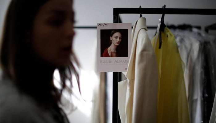 A clothes rack features an outfit to be worn by model Billie Adams before a show by the Australian fashion house Albus Lumen. REUTERS/Jason Reed