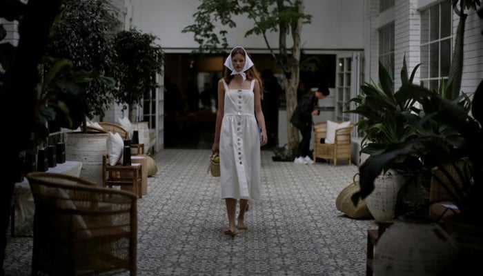 A model walks through an open air courtyard during a rehearsal for a runway show by Australian fashion house Albus Lumen. REUTERS/Jason Reed