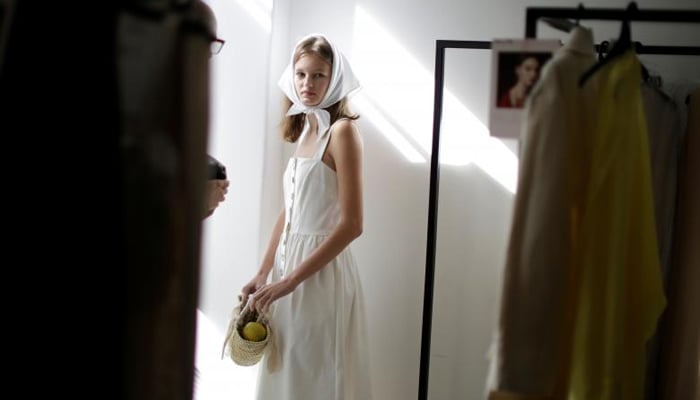 A model waits backstage before participating in a runway show by Australian fashion house Albus Lumen. REUTERS/Jason Reed