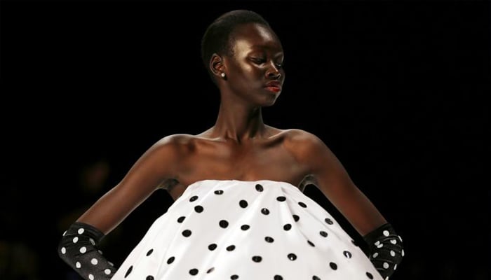 A model wears a polka dot dress during the St George Nextgen show. REUTERS/Steven Saphore