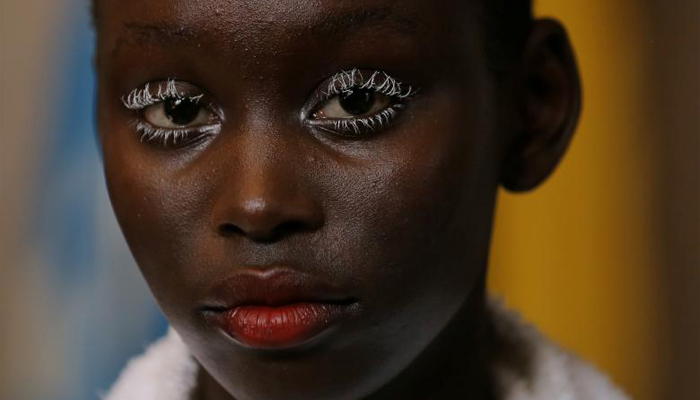 A model for designer Gary Bigeni looks on. REUTERS/Steven Saphorelooks