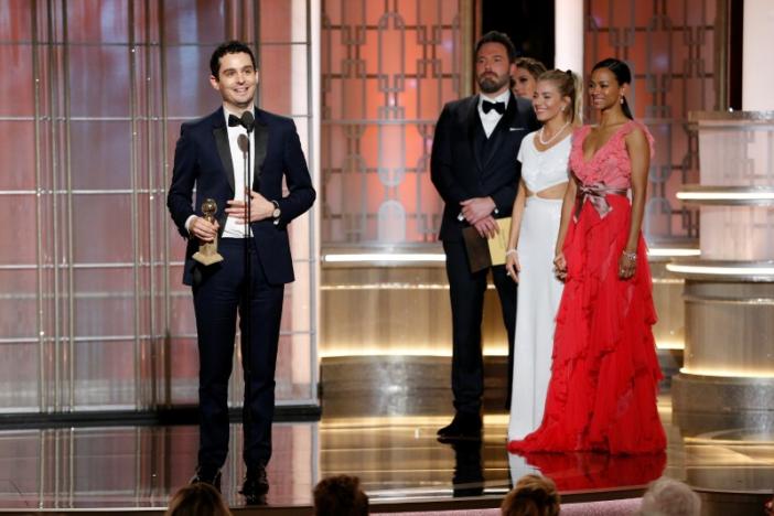 Director Damien Chazelle holds the award for Best Director - Motion Picture for 