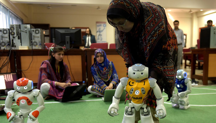  Pakistani students and team members of Robotics and Intelligence Systems Engineering (RISE) programme their robot football players in the engineering department of the National University of Sciences and Technology in Islamabad