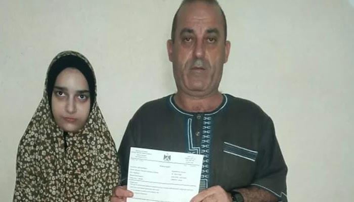 Walaah (left), 15, daughter of Youssef Hassan (right), is a resident of the besieged Gaza Strip