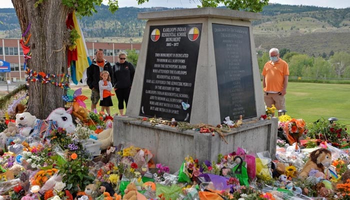 People visit a makeshift memorial on the grounds of the former Kamloops Indian Residential School, where the remains of 215 children were found. — Reuters/File