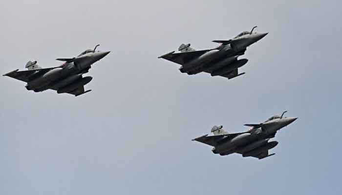 In this file photograph taken on February 3, 2021, Indian Air Force Rafale fighter jets fly past during the first day of the Aero India 2021 Airshow at the Yelahanka Air Force Station in Bangalore. — AFP