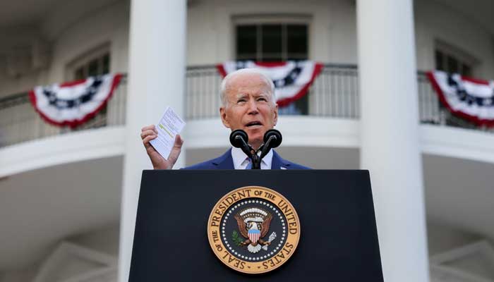 U.S. President Joe Biden holds a card with the number of deaths from the coronavirus disease (COVID-19) as he delivers remarks at the White House during a celebration of Independence Day in Washington, U.S., July 4, 2021. -REUTERS