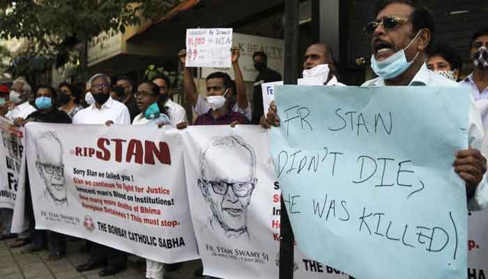 People hold banners and placards during a prayer meet for 84-year-old Indian Christian priest and activist Father Stanislaus Lourduswamy, commonly known as Stan Swamy, after he died in a hospital on Monday while awaiting bail after he was arrested under an anti-terrorism law, in Mumbai, India, July 6, 2021. — Reuters/Francis Mascarenhas