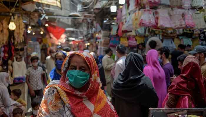 Women shop at a market in Rawalpindi. — AFP/File