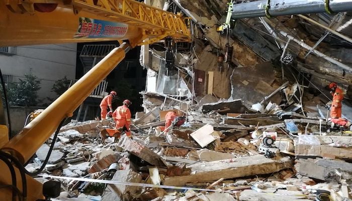 Rescue workers work at the site where a hotel building collapsed in Suzhou, Jiangsu province, China July 13, 2021. China Daily via REUTERS