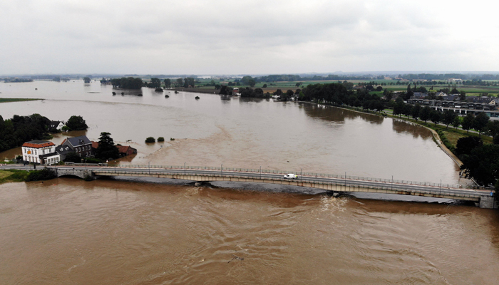 This aerial picture taken on July 16, 2021, shows the Maas river in Maaseik, northern Belgium, where the situation remains critical as the water keep rising after the heavy rainfall of the previous days. — AFP