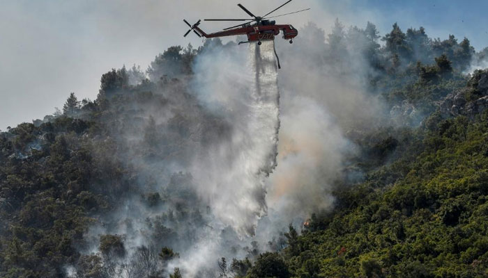 Hundreds of families homeless as Greek fires rage, rain saves Turkey