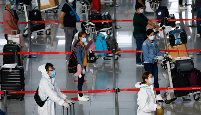 Passengers wearing personal protective equipment for protection against the coronavirus disease (COVID-19) queue at the check-in counters of Emirates airline, in Ninoy Aquino International Airport in Pasay City, Metro Manila, Philippines, July 9, 2020. — Reuters/File