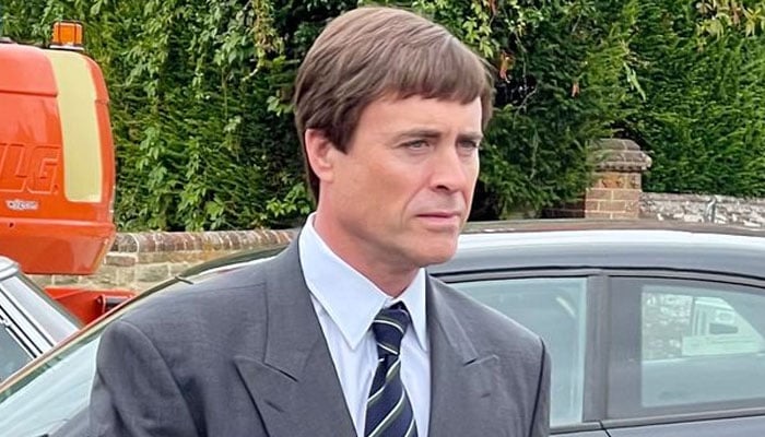 The image shows James Murray in a double-breasted suit and Prince Andrew’s signature fringe