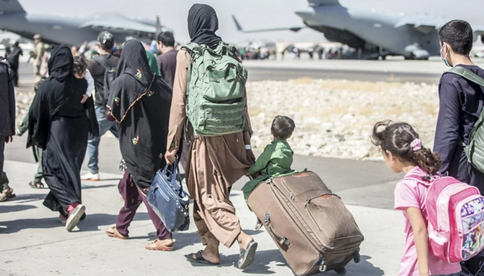 Afghan civilians head towards an aircraft during an evacuation at Hamid Karzai International Airport in Kabul, on 24 August 2021. — AFP/File