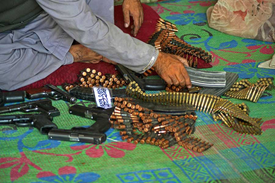 An Afghan vendor prepares ammunition to display for sale while waiting for customers in his shop at a market in Panjwai district of Kandahar province on September 4, 2021.  — Javed Tanveer/AFP