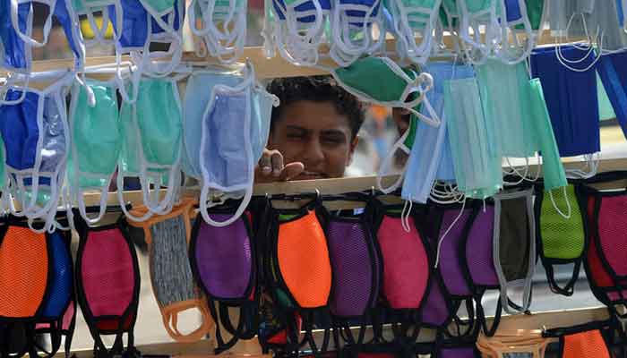 A vendor selling facemasks waits for customers along the streets of Karachi on June 8, 2020. Photo: AFP/File.