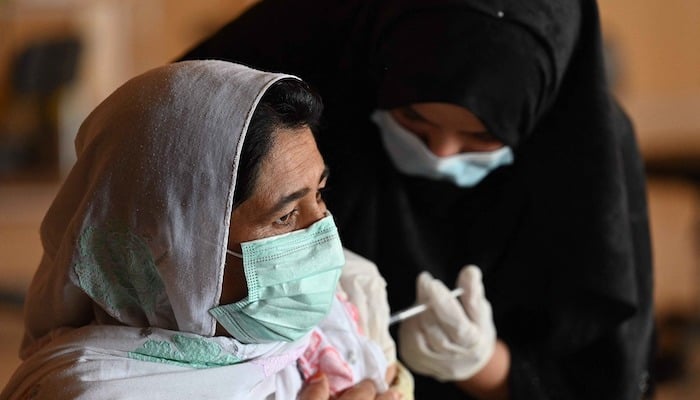 In this file photo, a woman receives the Covid-19 coronavirus Sinovac vaccine at a vaccination camp in Islamabad. Photo: AFP