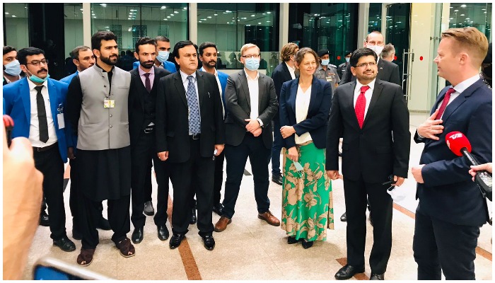 Denmark’s Foreign Minister, Jeppe Kofod (right) arrives at the Islamabad International Airport and talks to a Pakistani delegation. Photo: CAA.