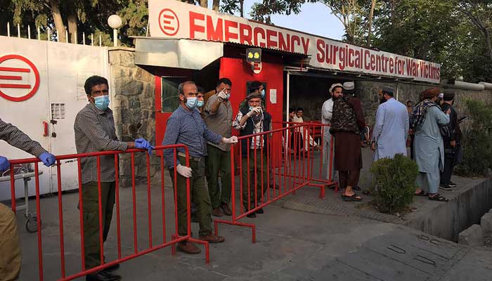 Afghan medical staff members stand at the entrance of a hospital as they wait to receive the victims of an explosion in Kabul on October 3, 2021. — Photo by Hoshang Hashimi/AFP