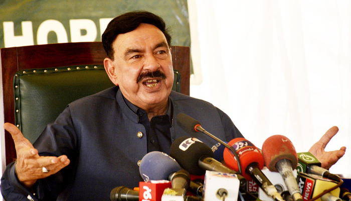 Interior Minister Sheikh Rasheed smiles during a press conference. — PID