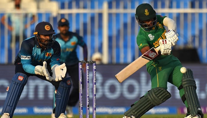 South Africa´s captain Temba Bavuma (R) plays a shot as Sri Lanka´s wicketkeeper Kusal Perera watches during the ICC Twenty20 World Cup cricket match between South Africa and Sri Lanka at the Sharjah Cricket Stadium in Sharjah on October 30, 2021. — AFP