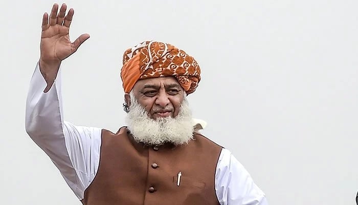 In this file photo, Jamiat Ulema-e-Islam-Fazl (JUI-F) chief Maulana Fazlur Rehman waves to party workers during a PDM jalsa. Photo: Geo. tv/file