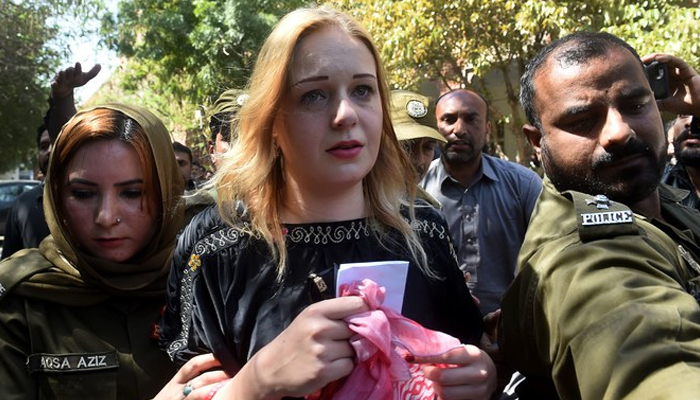 Pakistani police escort Czech model Tereza Hluskova after the court decision to sentence her to eight years and eight months in prison for attempted heroin smuggling, in Lahore on March 20, 2019. — AFP/File