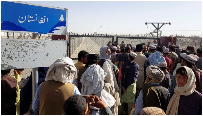 People gather as they wait to cross at the Friendship Gate crossing point in the Pakistan-Afghanistan border town of Chaman, Pakistan August 12, 2021. REUTERS