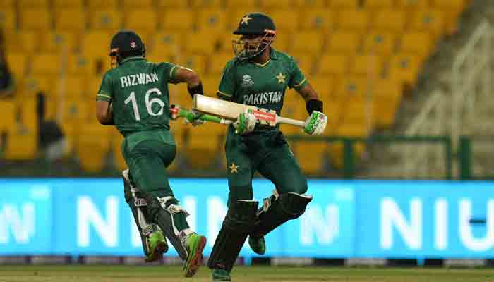 Pakistans wicketkeeper Mohammad Rizwan (L) and Babar Azam run between the wickets during the ICC Mens Twenty20 World Cup cricket match between Namibia and Pakistan at the Sheikh Zayed Cricket Stadium in Abu Dhabi on November 2, 2021.-AFP