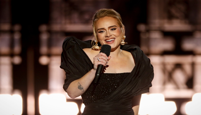 Adele tears up on surprise reunion with teacher mid-concert