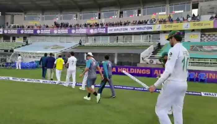 Shaheen Afridi and other Pakistani cricketers walk back to the pavilion after winning Dhaka Test. Photo: PCB Twitter video screengrab