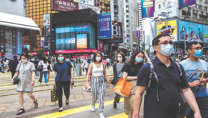 People walking on the streets of Hong Kong wearing masks. — AFP/ File.