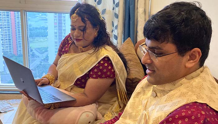 Bride and groom attending their wedding on Google Meet. — Twitter.com/vaayustudios/File