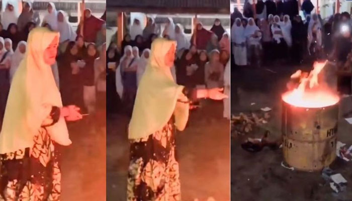 A teacher in Indonesia throwing students phones into pit of fire — Screengrab/Instagram