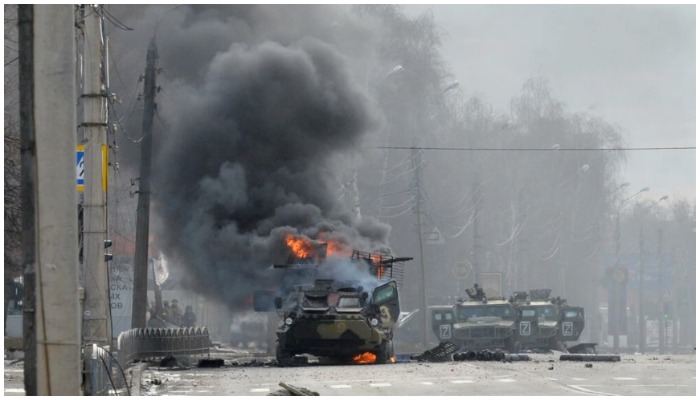 A Russian armoured personnel carrier burns next to an unidentified soldiers body in Kharkiv, Ukraines second-biggest city, following street battles — Sergey Bobok AFP/File