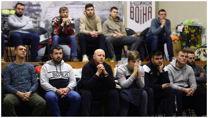 Volunteers for territorial defense listen to their instructor during their training at the warrior house, following Russias invasion of Ukraine, in Lviv, Ukraine, March 6, 2022. — Reuters/Kai Pfaffenbach