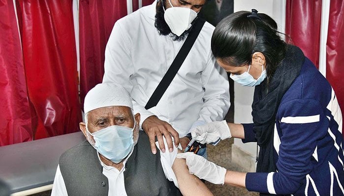 A senior citizen being administering the COVID-19 vaccine at the Red Crescent Coronavirus Care Hospital in Rawalpindi. — APP