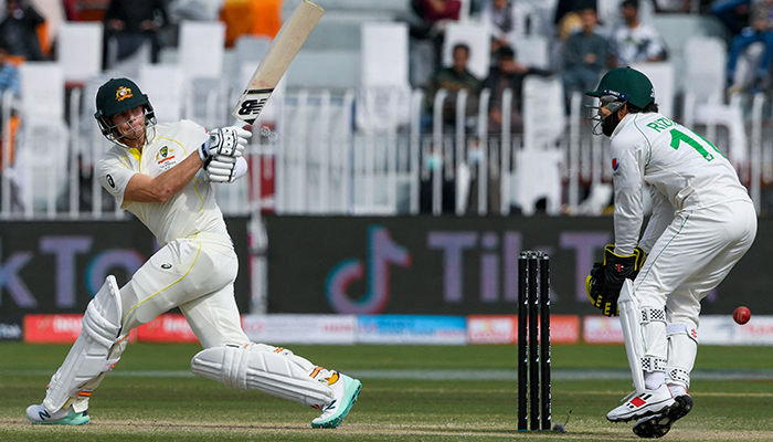 Australias Steven Smith (L) plays a shot during the fourth day of the first Test cricket match between Pakistan and Australia at the Rawalpindi Cricket Stadium in Rawalpindi on March 7, 2022. — AFP