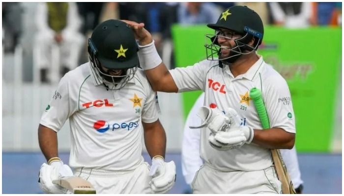 Pakistans Abdullah Shafique (left) and Imam-ul-Haq leave the field at tea on the fifth day of the first Test against Australia. — AFP