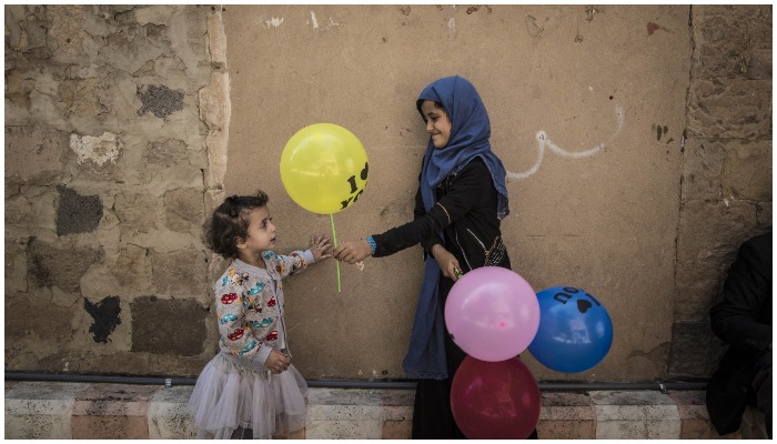 Representational image of a ballon seller handing over a balloon to a girl. — Reuters/File