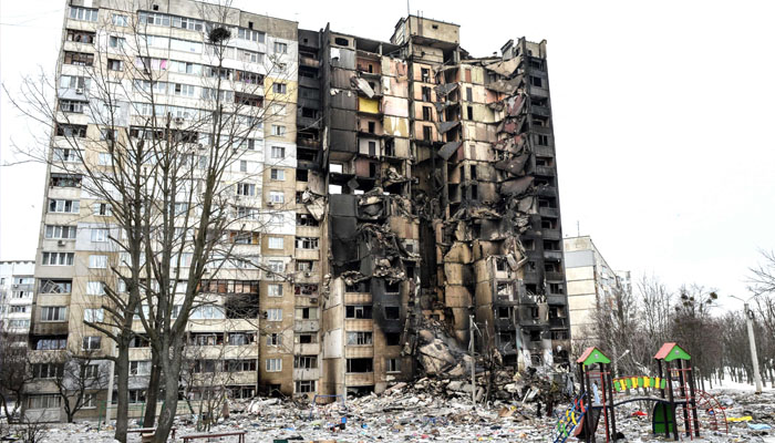 This picture shows an apartment building damaged after shelling the day before in Ukraines second-biggest city of Kharkiv on March 8, 2022. Photo— Sergey BOBOK / AFP