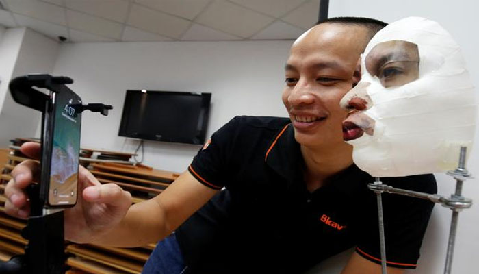 Ngo Tuan Anh, Vice President of Bkav, a Vietnamese cybersecurity firm, demonstrates iPhone X Apples face recognition ID software with a 3D mask at his office in Hanoi, Vietnam November 14, 2017. REUTERS/Kham