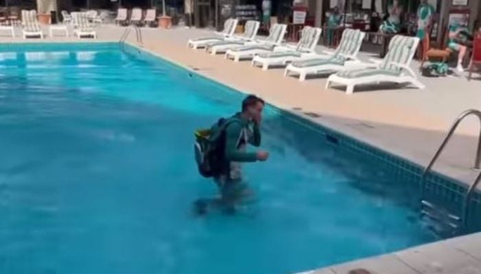 Australian wicket keeper Alex Carey falls into a swimming pool. Photo: Screengrab/Pat Cummins